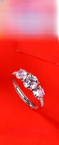 Detailed close-up of a 925 silver three-stone ring with an adjustable open band design