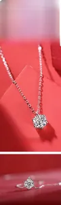 Macro shot of silver Moissanite necklace with classic six-prong setting on red background
