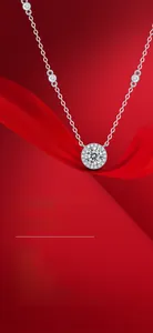 Macro detail of 925 silver halo pendant necklace with moissanite on red silk background
