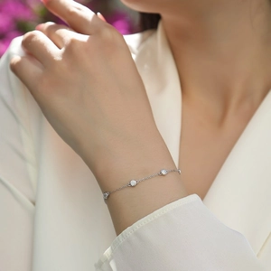 Elegant S925 sterling silver bracelet with round moissanite stones worn on a wrist