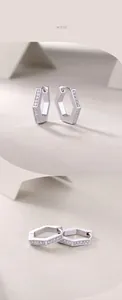 Detailed macro view of S925 silver hexagonal hoop earrings with sparkling moissanite stones