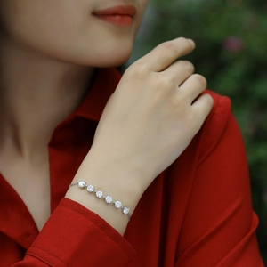 Sparkling S925 sterling silver moissanite bracelet on a model wearing a vibrant red shirt