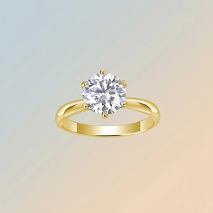 Minimalist gold S925 silver ring featuring a classic six-prong set round moissanite stone