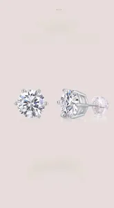 Macro shot of D-color 3EX round cut moissanite stud earrings with classic six-prong setting