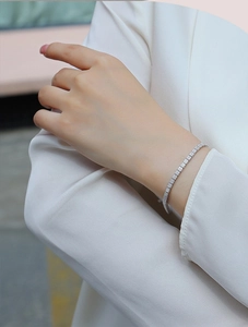 Close-up of S925 sterling silver tennis bracelet with square-cut moissanite on wrist