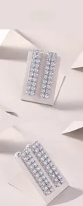 Detailed view of 925 silver tassel earrings featuring double-row inlaid square moissanite