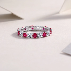 Detail of S925 sterling silver ring with alternating red and white round gemstones