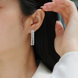 Elegant 925 silver tassel earrings featuring double rows of moissanite on female model