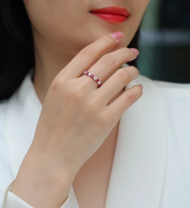 Detailed view of an S925 sterling silver band ring with red rubies and white diamonds