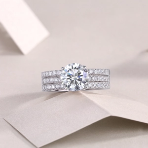 Macro detail of 925 silver moissanite ring set with round main stone and pavé bands