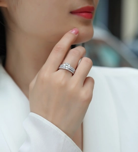 Detail showing two-piece 925 silver moissanite stackable rings set on a female model hand