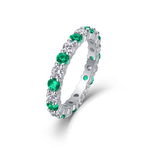 Close-up of S925 sterling silver eternity ring with green emeralds and diamonds