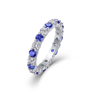 Macro shot of S925 silver eternity ring with alternating blue and white round cut gems