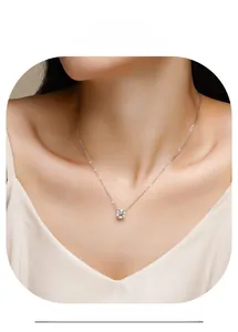 Close-up of minimalist 925 silver necklace with round moissanite pendant on female model