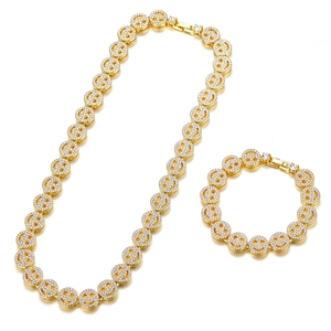 Detail of gold Cuban link chain set with micro-paved rhinestones and smiley face charms