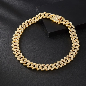 Detailed macro view of 20mm gold Cuban link chain with paved diamonds and secure buckle