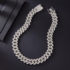 Detailed macro shot of 20mm silver Cuban link chain with double row crystals on black background