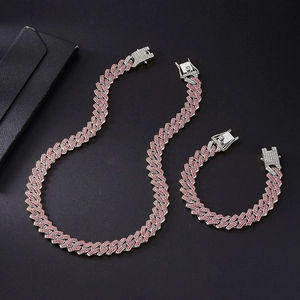 Detailed view of pink pavé Cuban link chain necklace and bracelet jewelry set