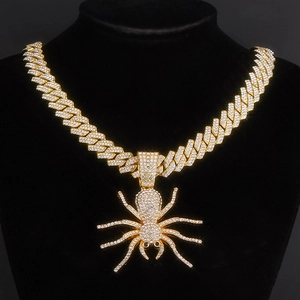 Macro shot of hip-hop golden spider pendant with sparkling zircon on cuban link chain