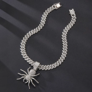 Close-up of hip hop spider pendant with iced-out crystals on a thick cuban chain