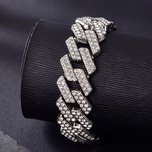 Close-up of 20mm silver Cuban link necklace with double row iced out rhinestones on black leather