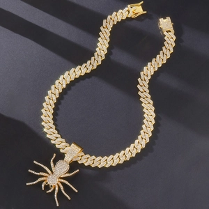 Iced out gold spider pendant necklace with sparkling crystals on heavy Cuban chain