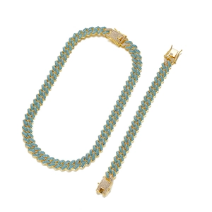 Detailed view of 14mm gold Cuban link set with micro-paved sky blue zircons