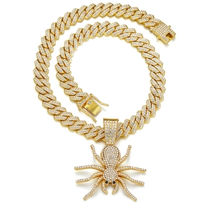 Iced out spider pendant with thick Cuban link chain in hip-hop style gold finish