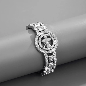 Macro view of iced out spinning cross bracelet with cubic zirconia in silver finish