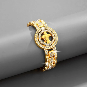 Macro shot of hip hop gold bracelet featuring iced-out dollar cross and watch link chain