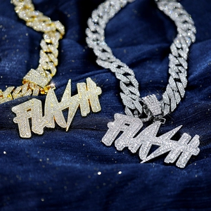 Close-up of hip-hop FLASH letter pendant with iced-out cubic zirconia on Cuban link chain