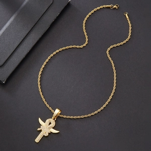 Detailed view of a gold-plated twist chain necklace with a winged Ankh cross pendant