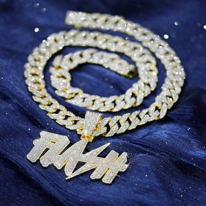 Close-up of iced out golden Cuban chain with FLASH lightning pendant on velvet