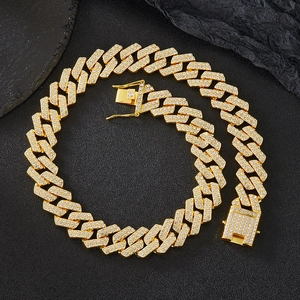 Macro view of 20mm gold Cuban link chain with high-density iced out pavé crystal stones