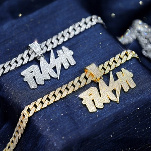Detail of gold and silver FLASH pendant with iced out cubic zirconia on Cuban link chain