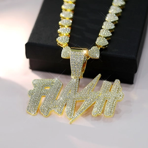 Macro shot of gold-plated FLASH pendant with heart-shaped link chain and crystal inlay