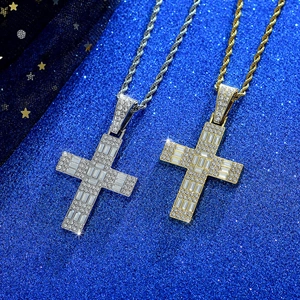 Close-up of gold and silver hip-hop cross pendants with baguette and round crystals