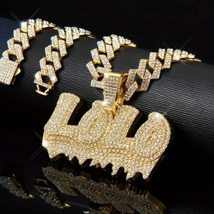 Detail of gold-plated iced out Cuban link chain set with LOL letter pendant and rhinestones