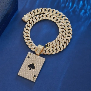 Macro detail of golden iced-out Ace of Spades pendant on heavy Cuban link chain