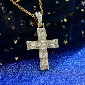 Macro detail of iced-out gold cross pendant with baguette zircons and rope chain