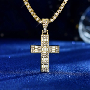Close-up of gold-plated hip hop cross pendant encrusted with glittering white zircons