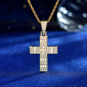 Detailed macro view of gold cross pendant with pave crystals and rope chain