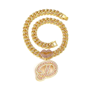 Close-up of hip-hop golden Cuban chain with pink rhinestone lips and letter D pendant