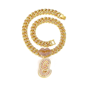 Macro view of gold-plated Cuban chain with pink rhinestone lip and number 8 pendant