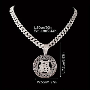 Detailed view of silver iced-out hip hop Fu character pendant with Cuban link chain