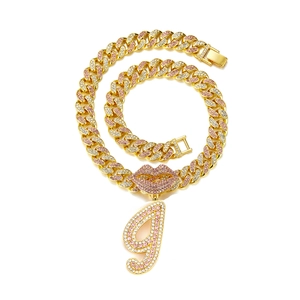 Macro detail of iced-out hip hop necklace with rhinestone lips and letter g pendant