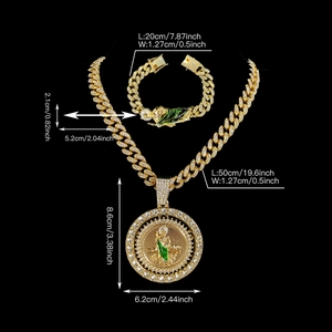 Close-up of hip hop gold Cuban chain set with iced out St. Jude green enamel pendant