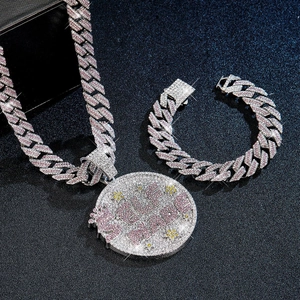 Macro shot of silver hip-hop jewelry set with 15mm cuban chain and iced-out pendant