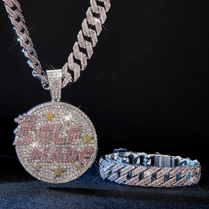 Detail of SELF MADE iced-out pendant and 15mm Cuban link chain with pink rhinestones