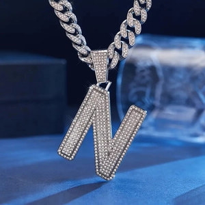 Iced-out silver letter N pendant with sparkly zircon stones on a chunky Cuban link chain
